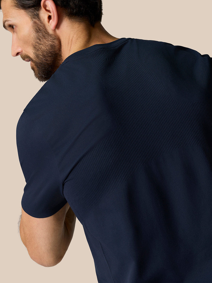 Close-up of midnight navy Zone Training T-Shirt fabric with ribbed shoulder panels.