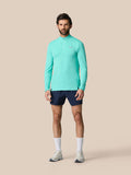 Full-body shot of a man wearing light aqua Zone Training 1/4 Zip Top with long sleeves and stand-up collar