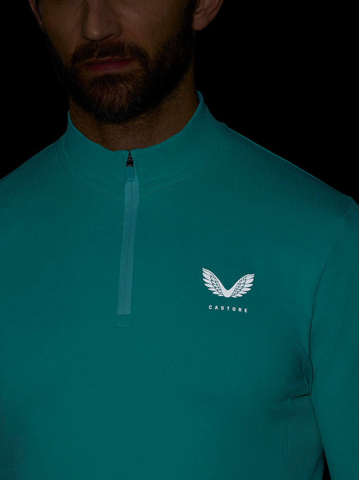 Front view of Zone Training quarter-zip top in teal with logo on the chest and zip detail.