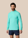 Male model wearing light aqua Zone Training 1/4 Zip Top with high neck long sleeves and chest logo