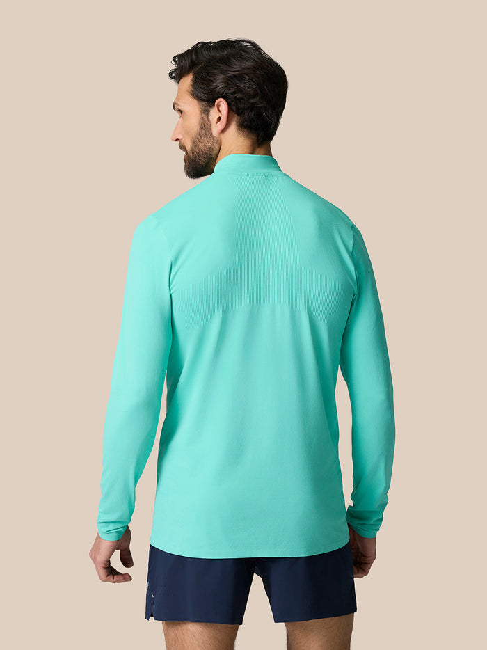 Back view of light aqua Zone Training 1/4 Zip Top on male model showing ribbed back panel and relaxed fit