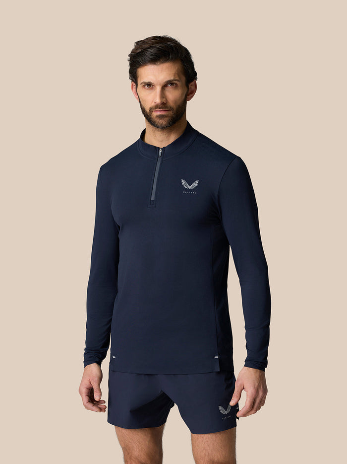 Male model in midnight navy Zone Training 1/4 Zip Top with long sleeves and high neck.