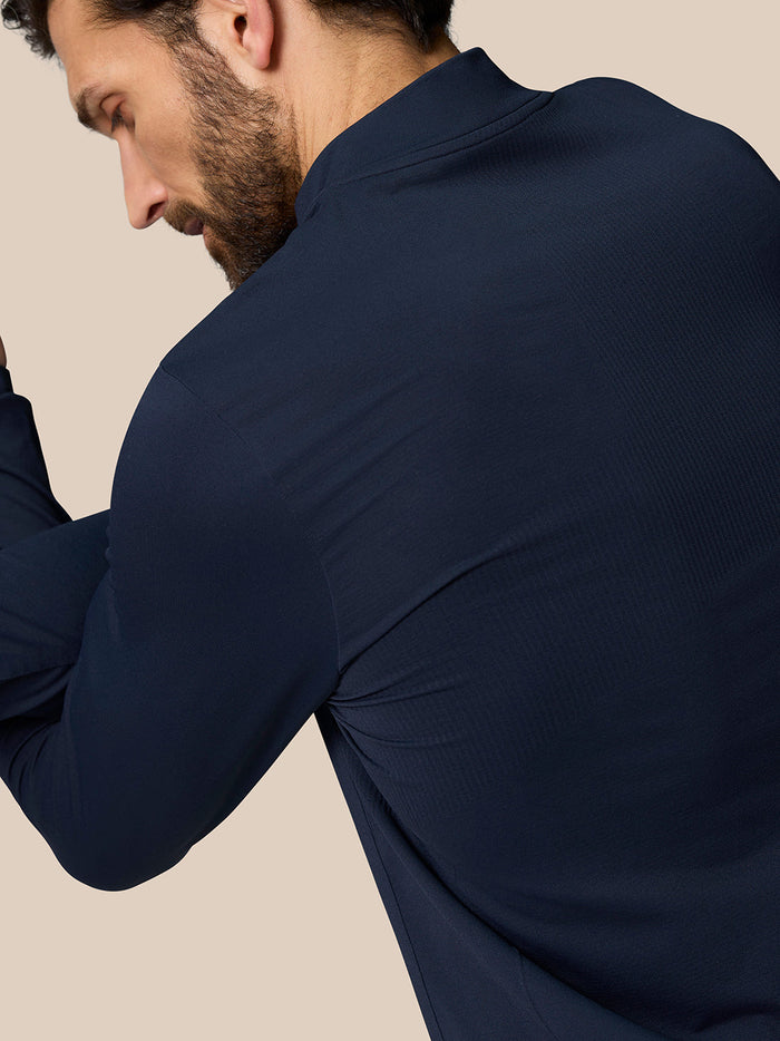 Back view of navy Zone Training 1/4 Zip Top highlighting mobility oriented knit fabric