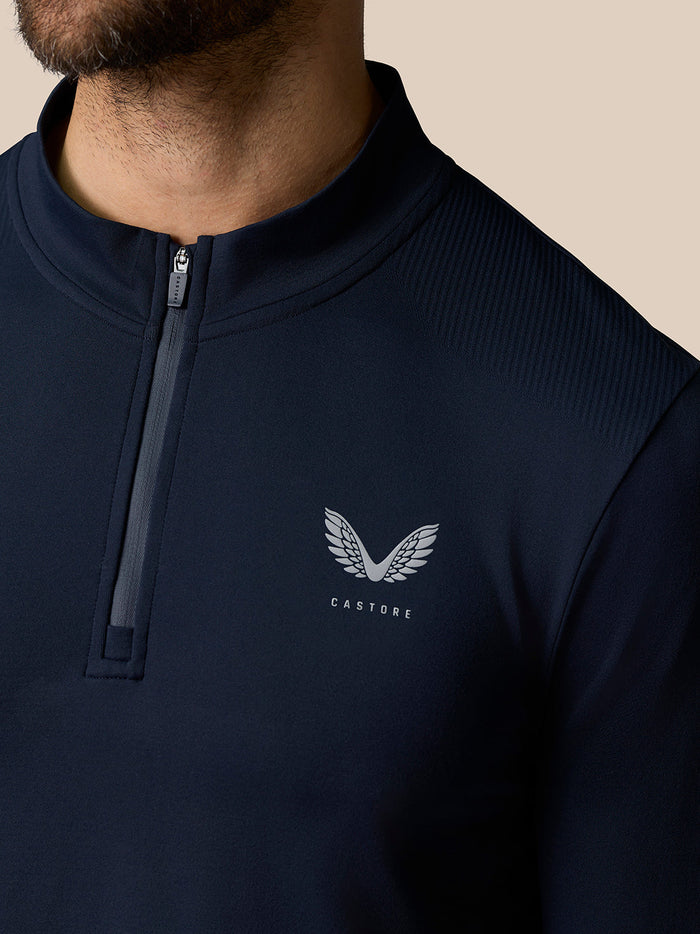Close up of navy Zone Training top with ¼ zip collar and chest logo.