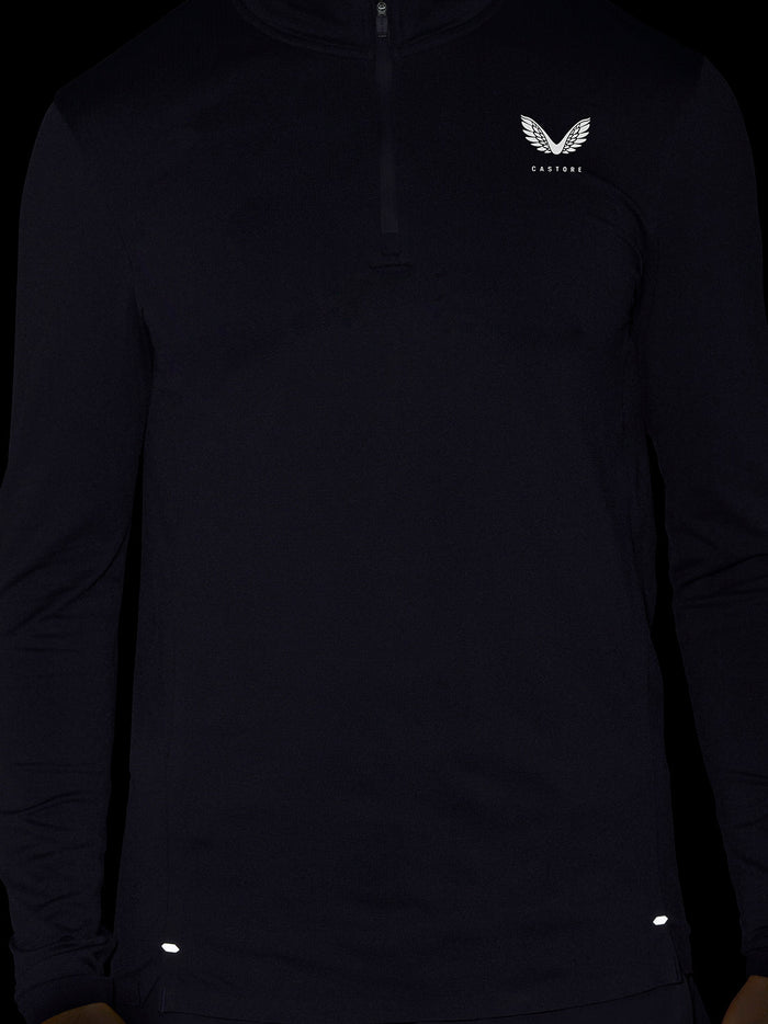 Black long sleeve top with quarter zip and small white wing logo on chest