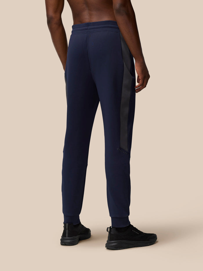 Back view of navy Flex Thermo Pant with a dark side panel and tapered ankle cuffs.