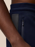 Close up of navy Flex Lifestyle Thermo Pant showing a zipped side pocket.
