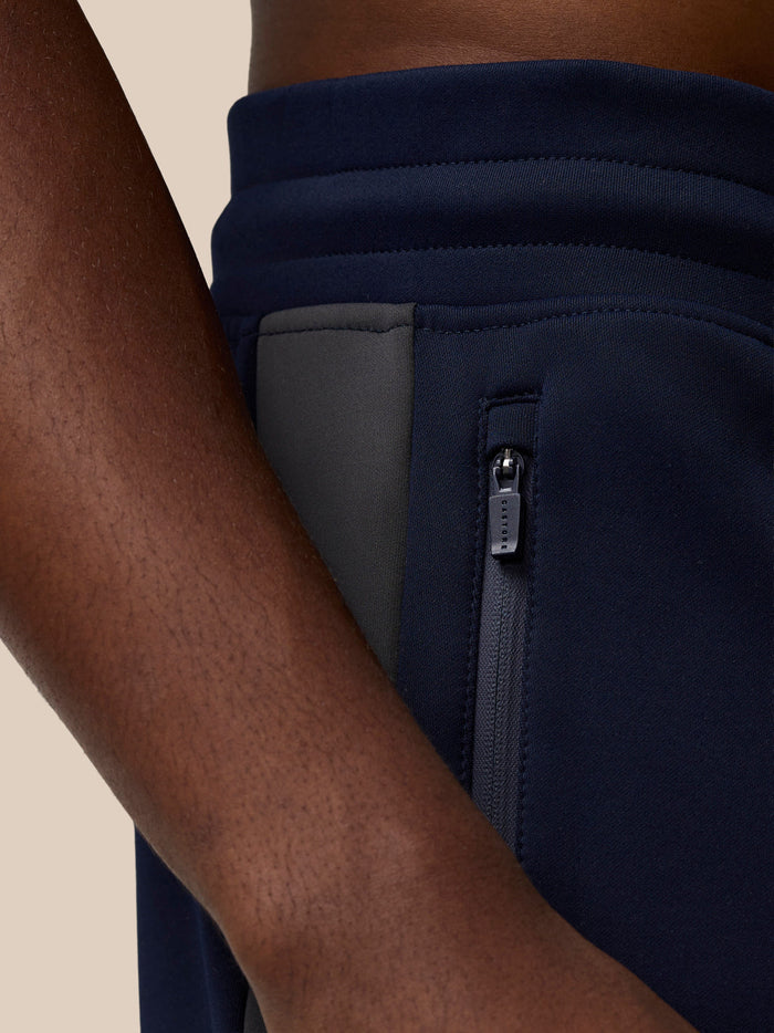 Close up of navy Flex Lifestyle Thermo Pant showing a zipped side pocket.