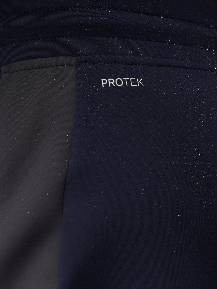 Close-up of navy fabric with water droplets highlighting ProTek water resistance.