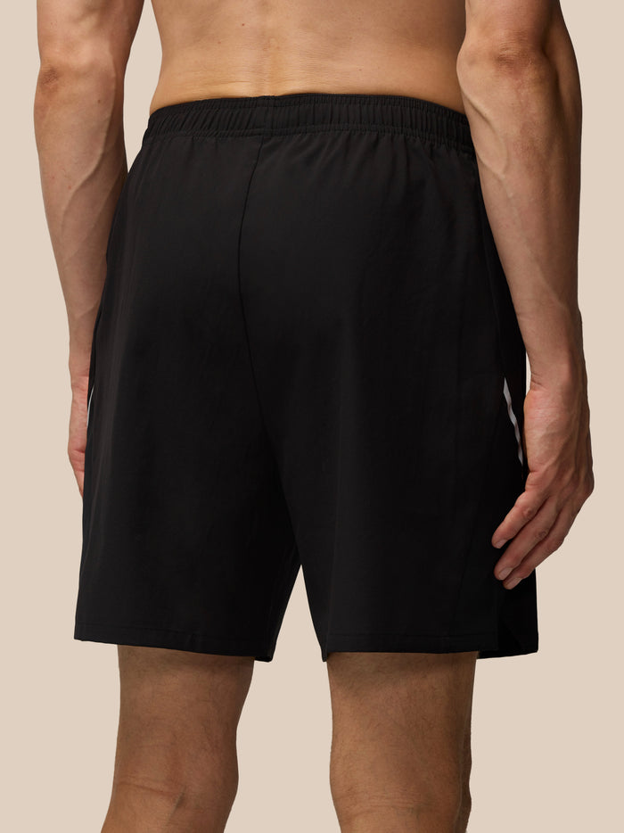 Back view of men's black Apex Training 6 inch shorts showing an elastic waistband and relaxed fit.
