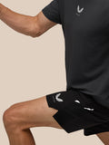 Side view of a man in black Apex Training 6 Inch Shorts with Castore logo on the leg and textured fabric