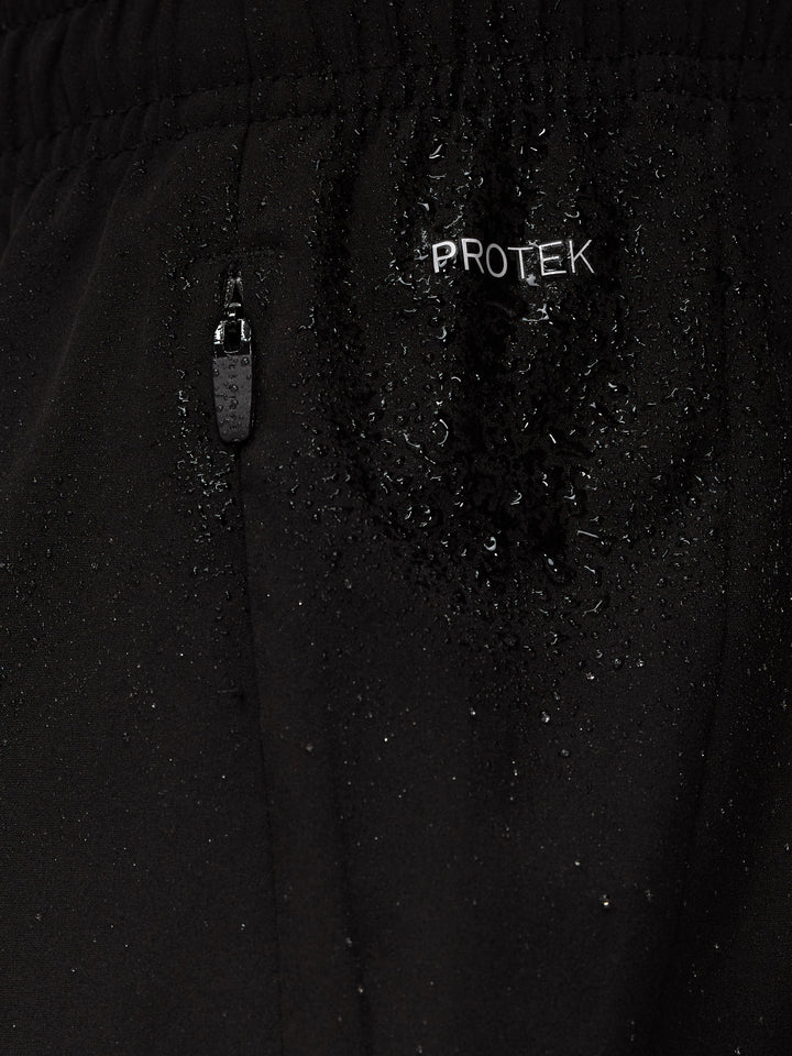 Close up of black Apex Training shorts fabric with ProTek logo, water droplets, and a zipper pull.