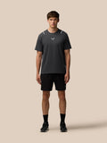 Male model wearing Apex Training T Shirt Gunmetal with reflective shoulder accents, full body front view.