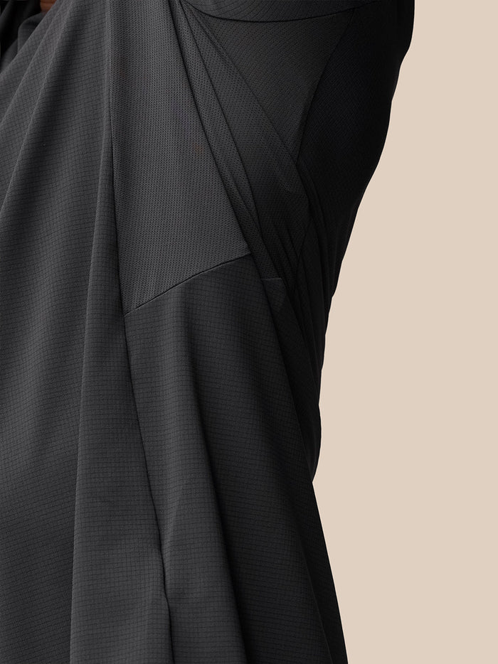 Close up of back hem area with Castore logo on dark Apex Training T Shirt fabric.