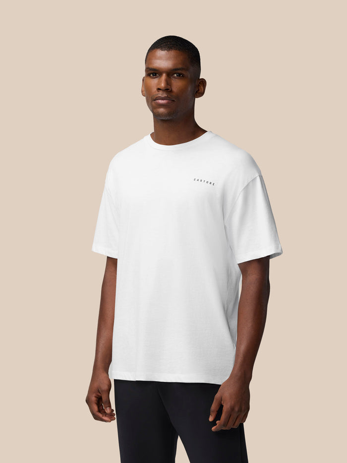 Man wearing white Flex Cotton T-Shirt with small Castore logo on left chest.