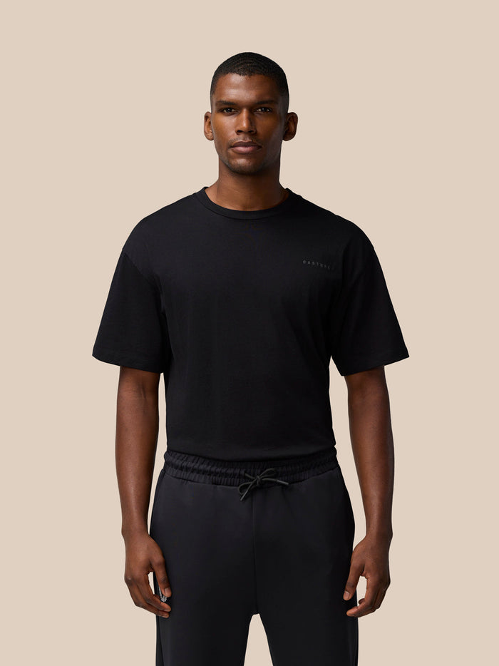 Front view of a male model wearing a black Flex Cotton T Shirt with a round neckline and a small chest logo.