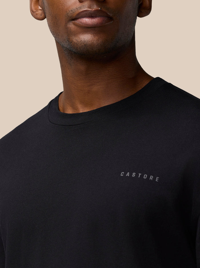 Close up of the black T shirt showing the CASTORE logo on the left chest and a round neckline.