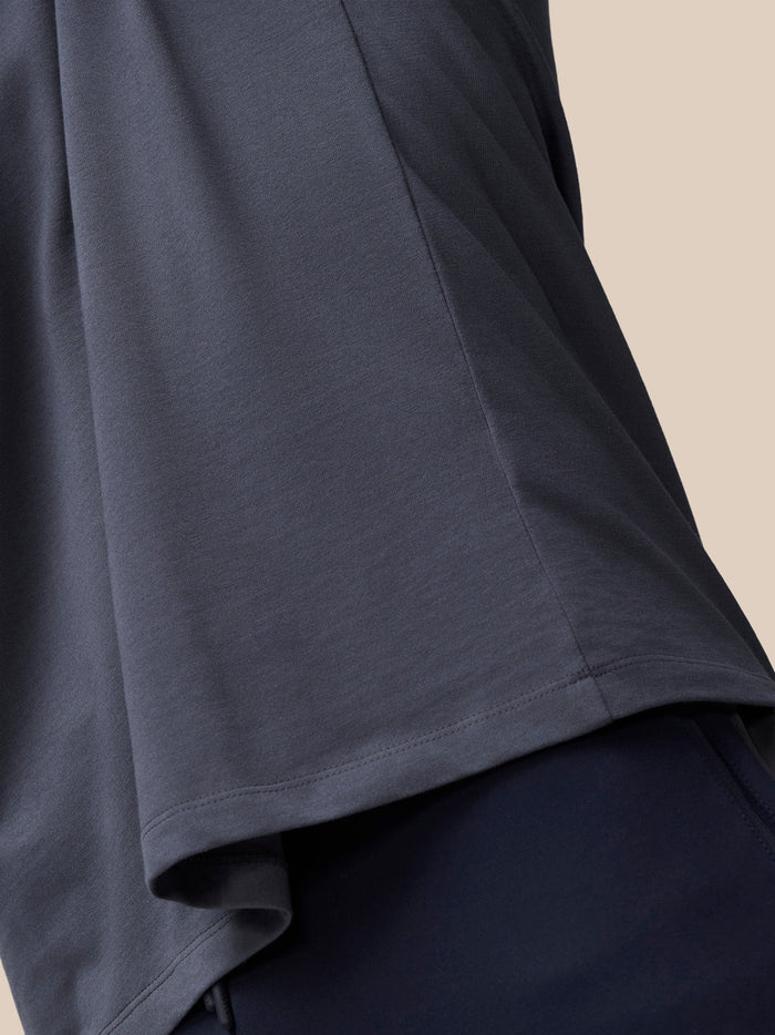 Close up of the sleeve and hem of a pewter alloy cotton T-shirt, showing soft knit fabric and neat stitching.