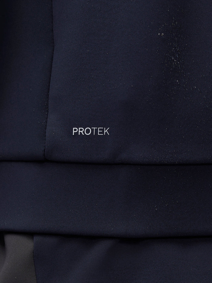 Close up of navy fabric with PROTEK branding along the seam.