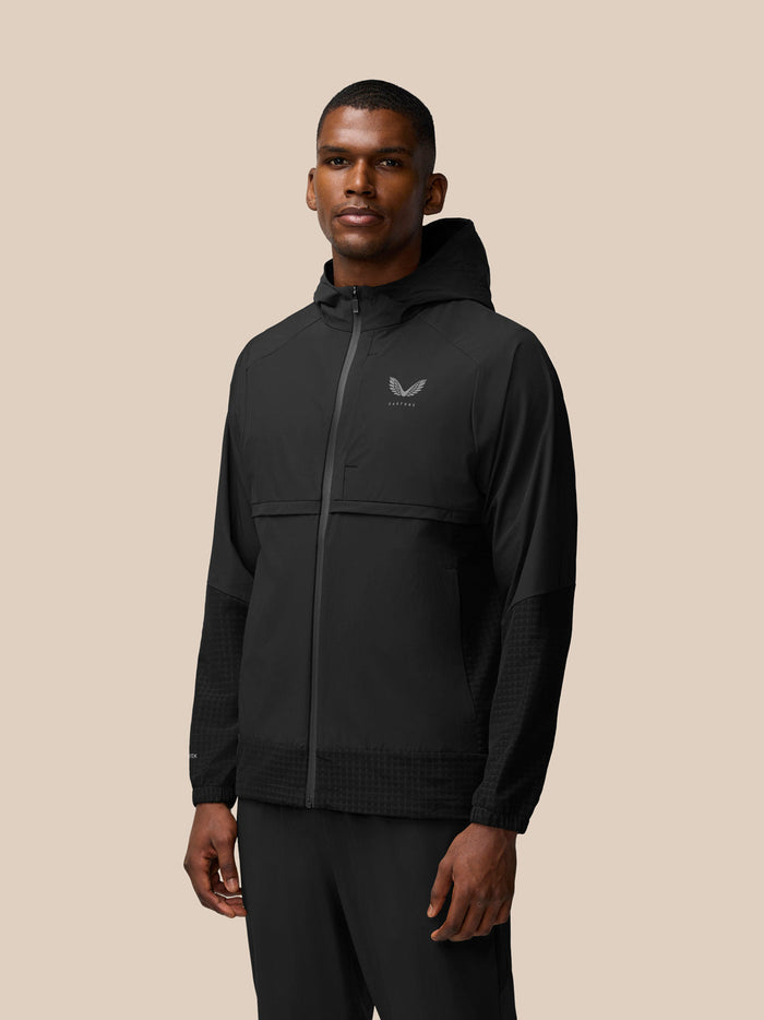Front view of black Flex Winterised Woven Jacket with hood and full zip, left chest Castore logo visible.