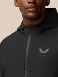 Close up of the jacket zipper and left chest Castore logo on a black Flex Winterised Woven Jacket.