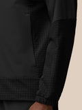 Close-up of black Flex Winterised Woven Jacket showing a textured grid pattern on the lower body and cuff