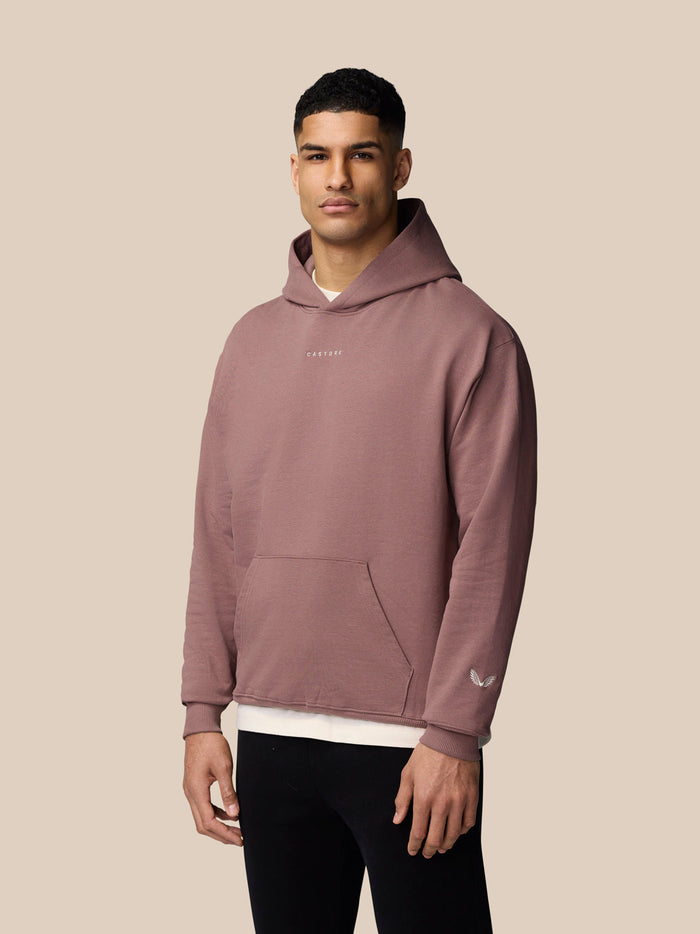 Male model wearing mauve Adapt Lifestyle Hoodie with hood and front pocket