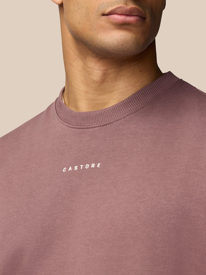 Close-up of mauve Adapt Lifestyle Sweatshirt chest showing Castore logo.