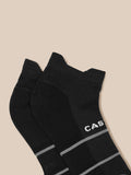 Close-up of black athletic socks featuring Castore branding and grey stripes
