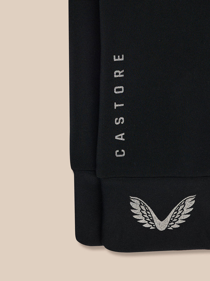 Close up of black glove cuff showing vertical CASTORE text and silver wing emblem