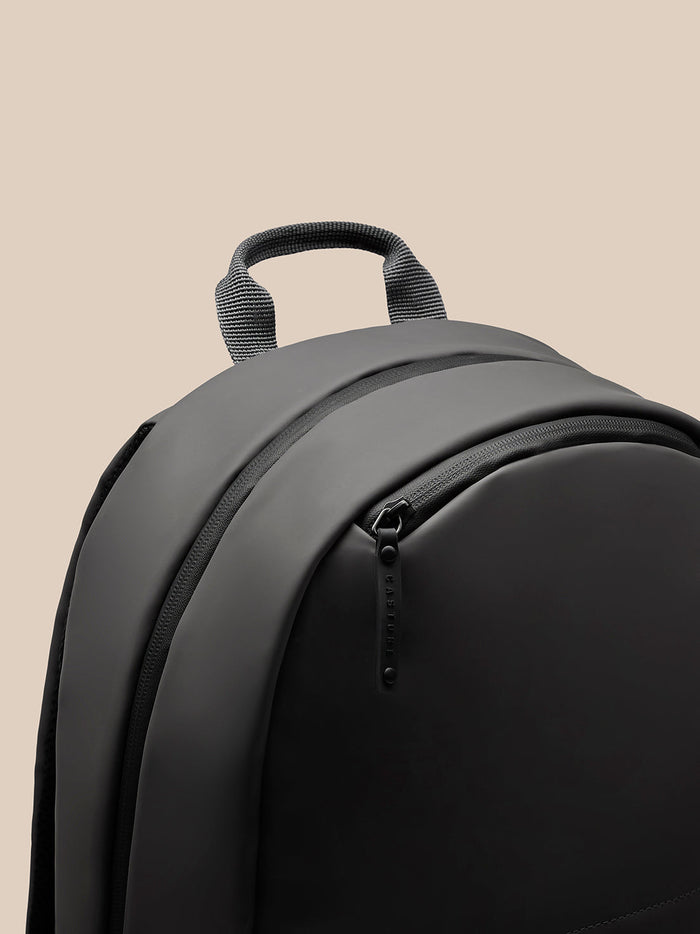 Close-up of charcoal Active Holdall showing a padded carry handle on a smooth polyurethane body