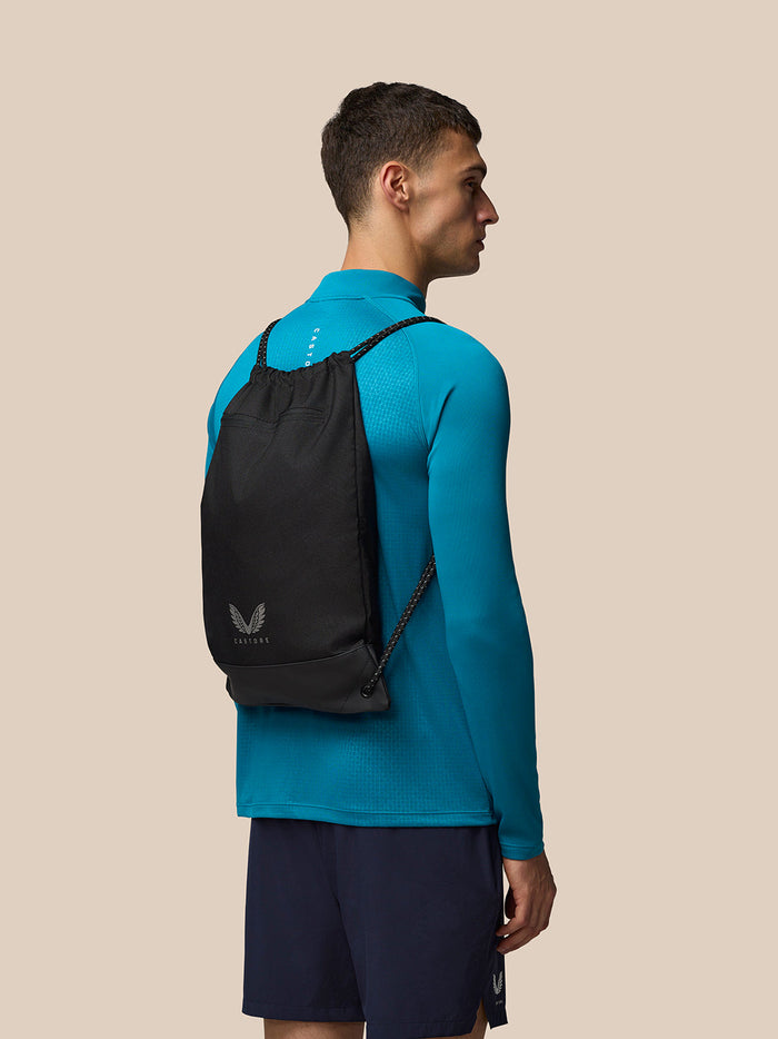 Close-up of the sack style opening with braided drawstrings on the black Castore gym sack