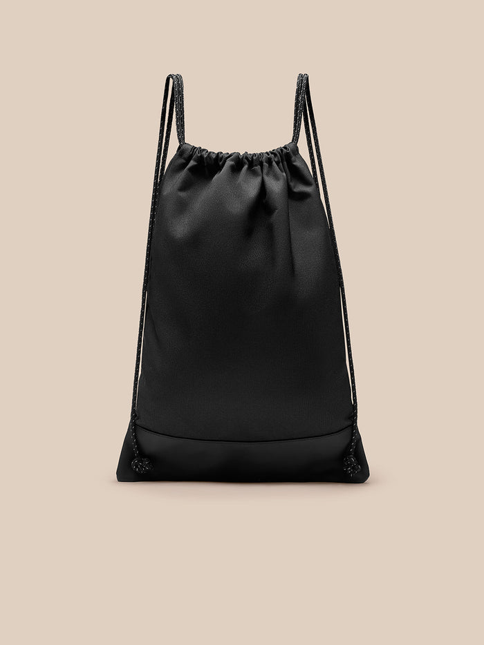 Front view of black polyurethane gym sack with sack style opening and double drawstrings, Castore branding at center