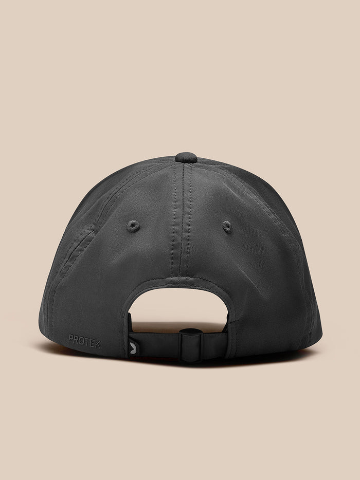 Back view of gunmetal Core Cap with adjustable strap and Protek branding.