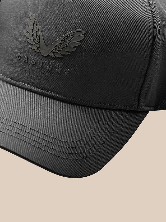 Close up of a gunmetal Castore cap with embossed wings logo and branding