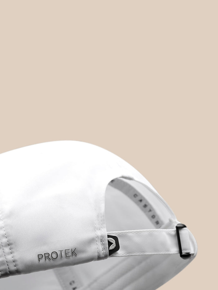Close up of back of white nylon cap showing adjustable strap with size markings and PROTEK branding.