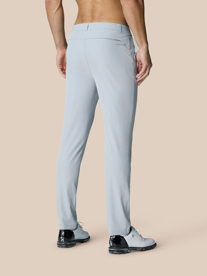 Back view of light grey Golf Club Trousers on a male model, showing the rear welt pocket and subtle branding.