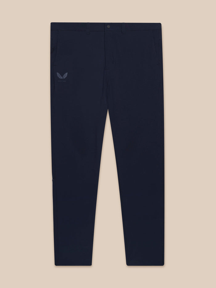 Midnight navy men's golf trousers laid flat showing front pockets and Castore logo on left thigh