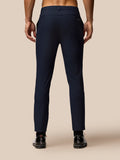 Back view of midnight navy golf trousers on a male model showing a welt back pocket and waist belt loops.