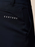 Close-up of navy golf trousers back pocket area with Castore branding on dark fabric.