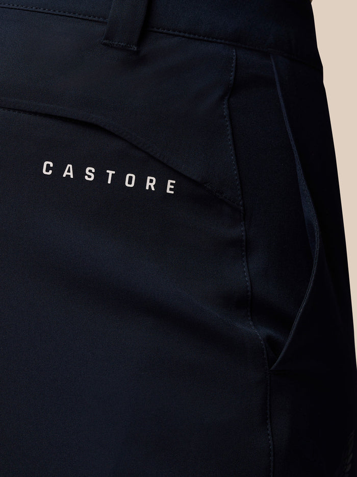 Close-up of navy golf trousers showing Castore branding near the back pocket