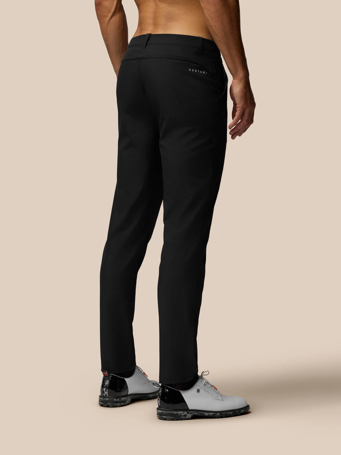 Back view of a man in black golf trousers showing back pocket with Castore branding