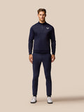 Full length shot of a man wearing navy Golf Lightweight Club Trousers with a matching navy top.