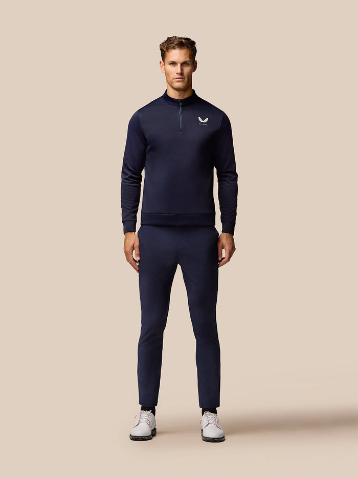 Full length shot of a man wearing navy Golf Lightweight Club Trousers with a matching navy top.