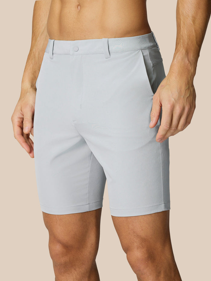 Light grey Golf Shorts featuring a flat front belt loops and side pockets on a model.