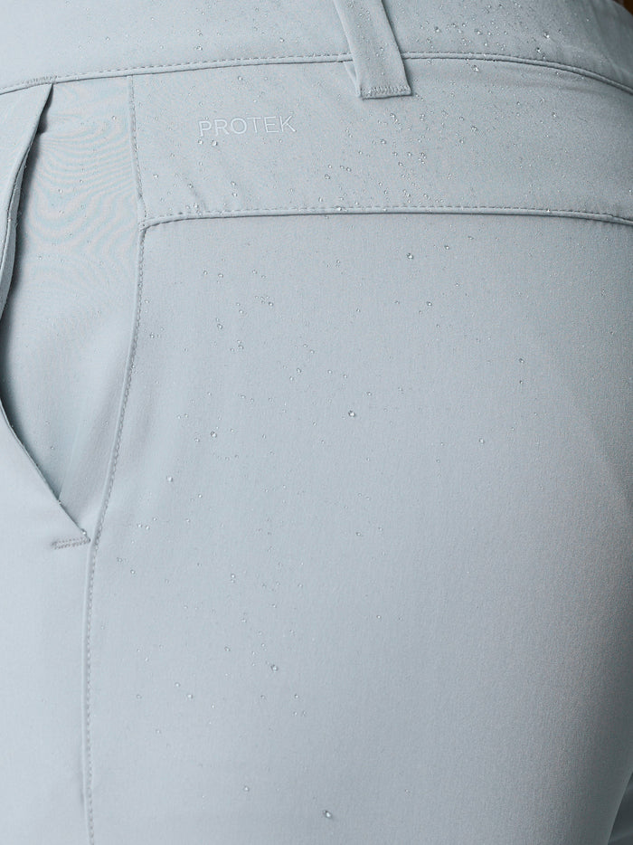 Close-up of ProTek water resistant fabric with droplets on light grey golf shorts