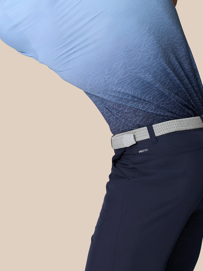 Side view of navy Golf Club Shorts with a light braided belt and ProTek branding at the waistband.