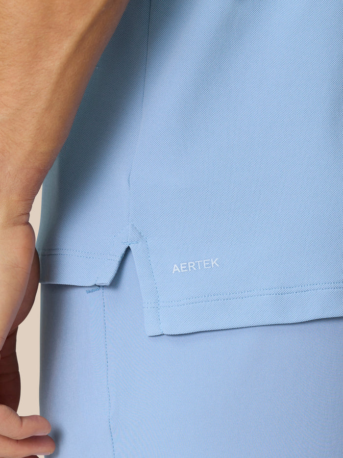 Close-up of sky blue polo fabric showing AERTEK label near the hem
