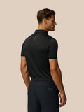 Back view of a man wearing the black Pinnacle Pique Stripe Polo.
