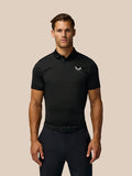 Model wearing black Golf Pinnacle Pique Stripe Polo with horizontal stripes and white Castore logo on chest